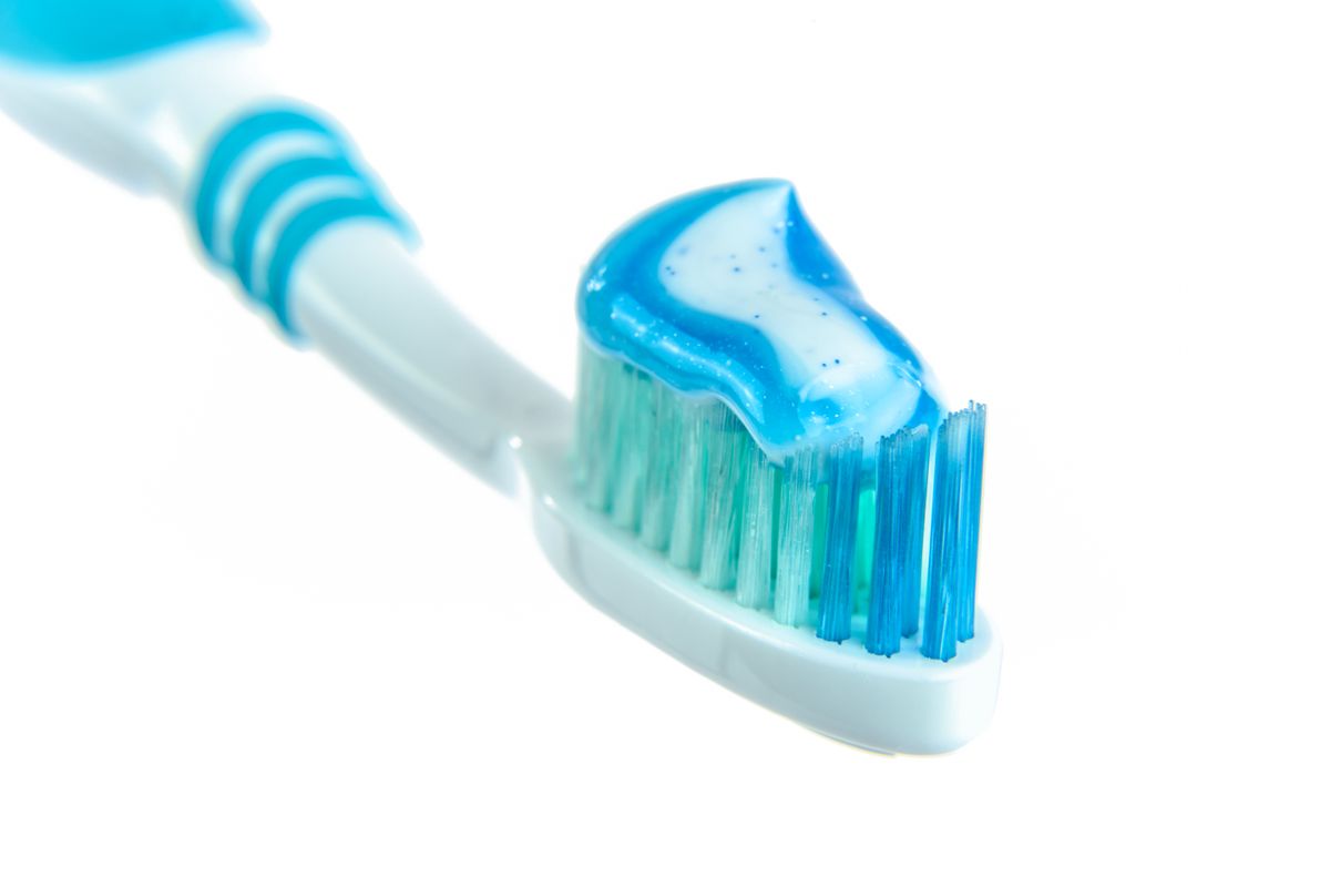 Close-up of blue gel toothpaste swirled on a toothbrush head